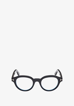 Occhiali in acetato nero con lenti rotonde, dettagli in azzurro chiaro e particolari in metallo sulle astine. Presentano una forma audace e unica.