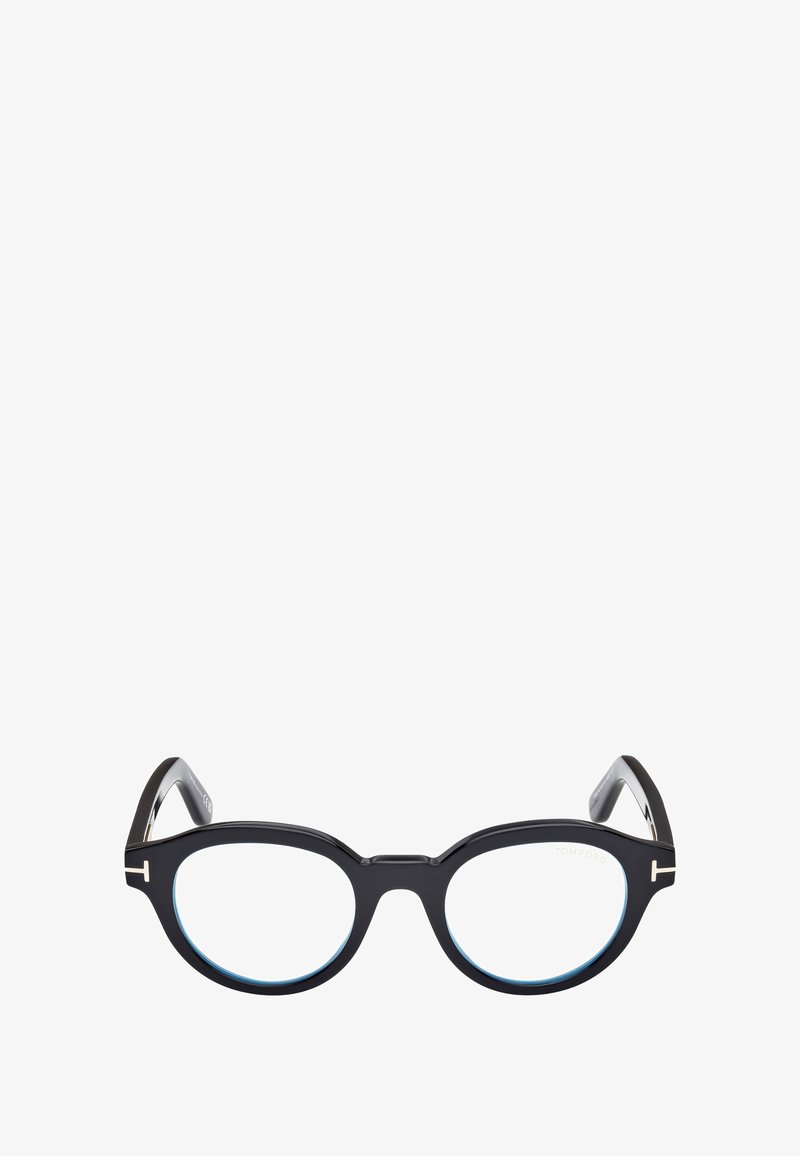 Occhiali in acetato nero con lenti rotonde, dettagli in azzurro chiaro e particolari in metallo sulle astine. Presentano una forma audace e unica.