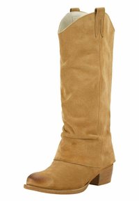 Lichte suède westernlaars tot halverwege de kuit met een afgeronde neus, lage gestapelde houten hak en trekriempjes aan de bovenkant aan beide zijden.