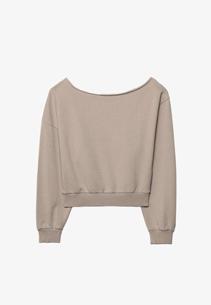 Svetlo bež kratka majica z dolgimi rokavi, ladijskim izrezom ter rebrastimi manšetami in pasom.