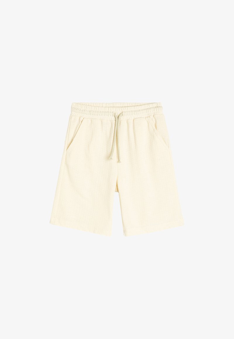 Lys beige shorts lavet af et struktureret stof, med en elastisk talje, snøre og to sidelommer.