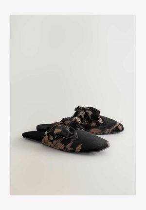 Black slippers with a floral pattern in copper, featuring a bow accent. Made of soft fabric with a pointed toe design and flat sole.