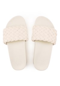 Woven strap slide sandals in off-white. Soft textured upper and flat sole. Minimalist design with rounded edges and subtle branding.