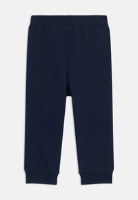 Leggings en coton bleu marine avec une texture douce, une taille élastique et des poignets ajustés, présentant une coupe droite et sans motifs visibles.