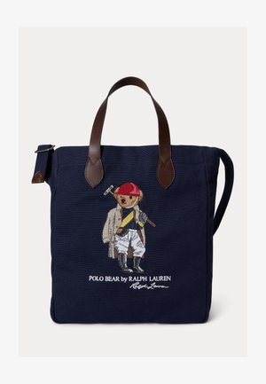 Borsa a tracolla navy con manici in pelle marrone, caratterizzata da un Polo Bear ricamato con abbigliamento da cavalcata che tiene un mazzuolo da polo, e logo Ralph Lauren.