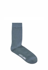 Szara skarpetka z prążkowanym mankietem, gładką teksturą i białym logo z napisem "JACK & JONES" po boku. Klasyczny fason do kostki.