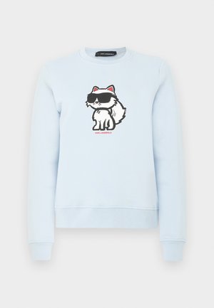 Heledsinine kampsun, mille rinnaku keskel on joonistatud koomiksitegelane valge kass, kes kannab suuri musti prille, väikese punase tekstiga allpool.