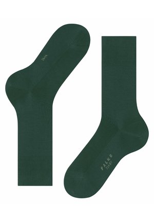 Dark green socks with a smooth texture, featuring a rounded toe and a ribbed cuff. The brand name, "FALKE," is printed in a light color.