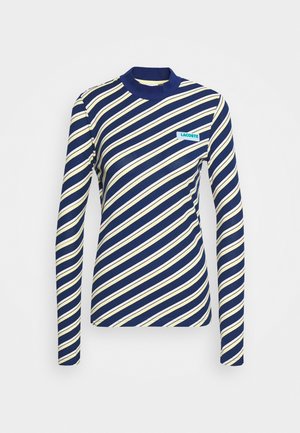 Tröja med lång ärm i marinblått och krämfärgat diagonalt randmönster, hög krage och en turkos Lacoste-logotyp på vänster bröst. Elastiskt tyg.