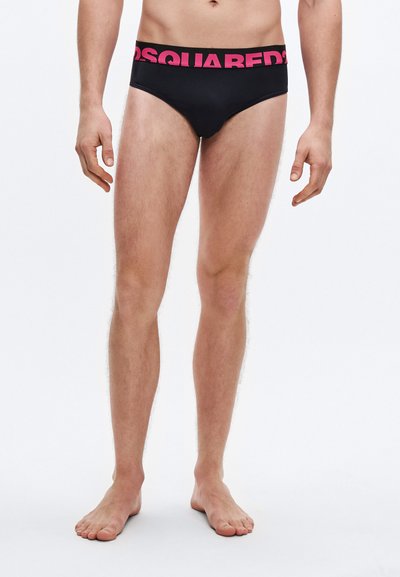 Black swim briefs with a wide fuchsia waistband displaying the logo "DSQUARED2." Material appears smooth, with a fitted cut.