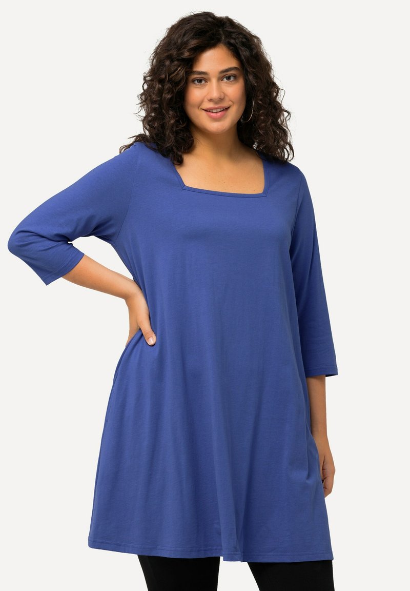 Blauwe tuniek met lange mouwen en een vierkante halslijn, met een losse pasvorm, gemaakt van zachte stof, met zijzakken en een gladde textuur.