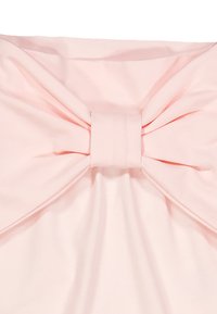 Top in tessuto rosa con un evidente dettaglio a fiocco nella parte anteriore, texture liscia e design dal fit rilassato.