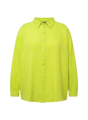 Chemise boutonnière vert citron avec une coupe décontractée, tissu texturé, col et boutons argentés sur le devant. Manches longues et ourlet droit.
