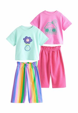 Deux hauts à manches courtes, l'un bleu clair avec un graphisme de fleur et de vase, l'autre rose avec une maison et le texte "Home is my happy place", accompagnés de shorts colorés.