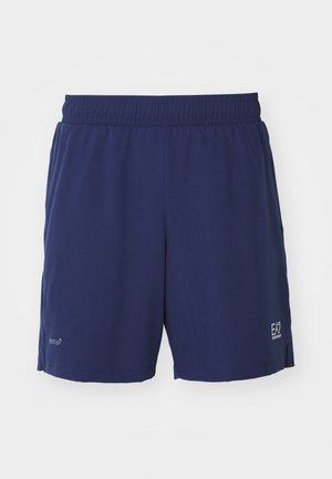 Tamsiai mėlyni sportiniai šortai su elastine juosta, pagaminti iš lygaus audinio, su logotipu ir prekių ženklų pavadinimu spausdintu apatinėje kairėje pusėje.