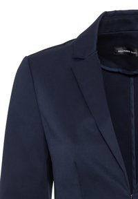 Navy blue blazer featuring a structured collar, smooth texture, and single-button closure. Label reads "HALLHUBER BASIC."