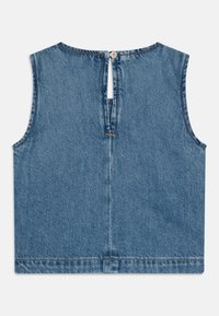 Blå denim ärmlös topp med rundad halsringning, knäppning baktill och rå fåll. Har en ren, enkel design och en slät textur.