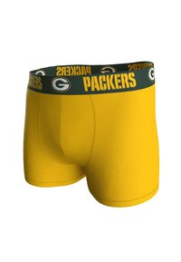 Boxer shorts amarillos con una cinturilla verde que lleva el texto "PACKERS" y un logotipo, fabricados con un material suave y elástico.
