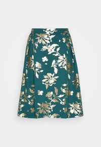 Jupe trapèze bleu sarcelle avec motif floral métallique doré, taille haute et plis sur les côtés, présentée sur un fond clair uni.