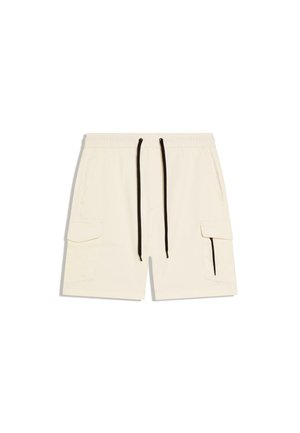 Bézs színű cargo rövidnadrág elasztikus derékpánttal, fekete húzózsinórokkal, oldalzsebekkel, valamint egy cipzáras zsebbel a jobb lábszáron.