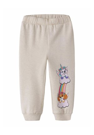 Pantalon beige pour enfants avec taille et poignets élastiques, avec un motif coloré de licorne et de chien avec des couronnes de fleurs sur un arc-en-ciel et des nuages, sur une jambe.