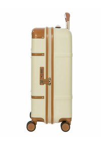 Maleta rígida en color crema con acentos marrones, equipada con un asa retráctil, cuatro ruedas, cerradura combinada y diseño acanalado texturizado.