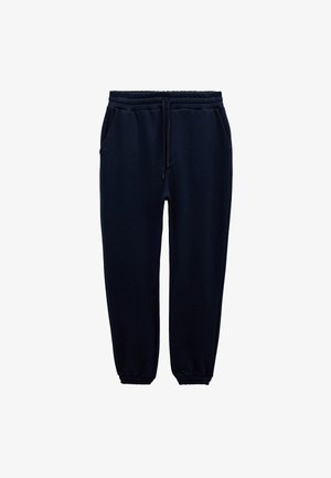Mørkeblå sweatpants lavet af blødt stof; har en elastisk talje med snor, sidelommer og elastiske mansjetter.