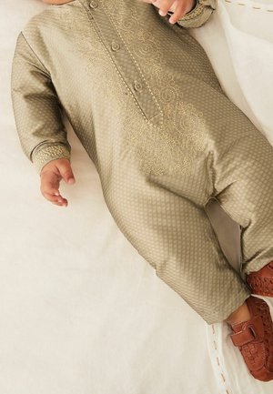 Olive green baby romper with intricate gold embroidery, featuring a buttoned neckline and long sleeves, paired with brown woven shoes.