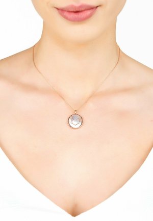 Rose gold pendant necklace with a round, faceted clear stone, suspended from a delicate chain. Smooth texture; minimalistic design.