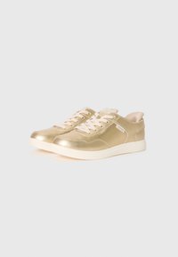 Pair of low-top metallic gold sneakers with light pink laces and white rubber soles on a white background.