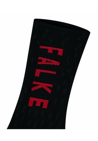 Calzino nero con texture a coste e audace scritta "FALKE" rossa di lato. Progettato per comfort e durata.