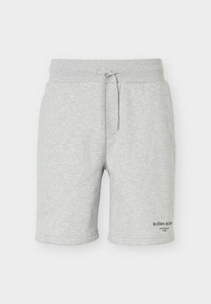 Heledad halli vabaajashorts, elastse vöökohaga, paelaga, küljetaskutega ja väikese musta logotekstiga alumisel vasakul säärel.