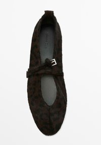 Black and brown leopard-print flats, made of textured fur, with a rounded toe and a thin strap featuring silver hardware detail.