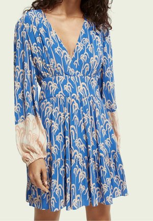 Blue dress with a deep V-neck, puff sleeves in light pink, and an all-over cream pattern. Flared skirt with gathered detailing.