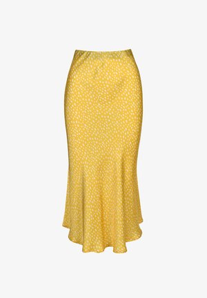 Žlutá sukně s rozšířeným lemem, zdobená vzorem bílých nepravidelných teček. Vyrobena z hladké, lehké látky s elastickým pasem.