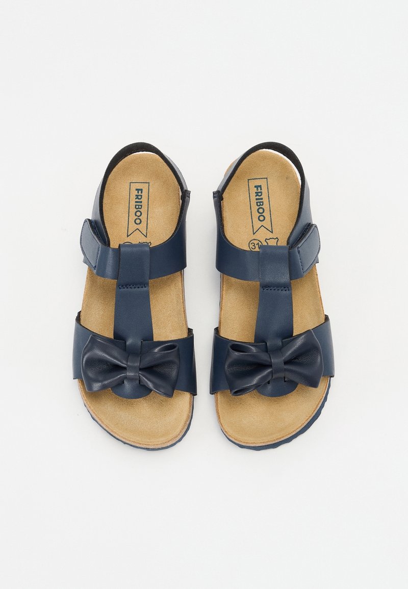 Sandales enfant bleu marine avec semelles intérieures couleur beige, brides réglables et nœuds décoratifs sur les brides des orteils, taille 31.