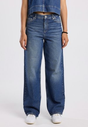Light blue wide-leg denim jeans with a faded finish. Features classic five-pocket design and metal button closure.