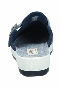 Sandal with a navy blue felt upper and grey lining, featuring an adjustable strap and a textured, white rubber sole.