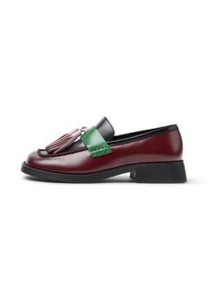 Mahoniekleurige leren loafer met zwarte bies, groene band, roze kwastjes aan de voorkant en lage zwarte hak, zijaanzicht op witte achtergrond.