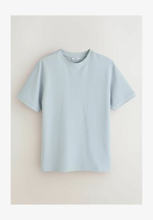 T-shirt en coton texturé bleu clair à manches courtes avec col rond, présenté sur un fond neutre uni.