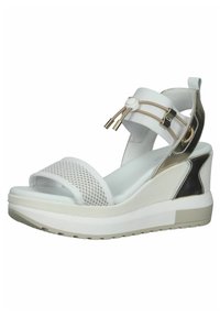 Wedge sandal with a white mesh upper, metallic silver accents, and a thick white outsole. Features adjustable straps and textured materials.