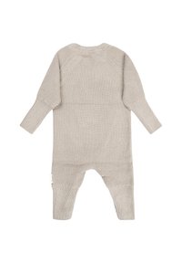 Soft beige knitted baby romper with long sleeves and footed legs, featuring textured stitch pattern and a round neckline.