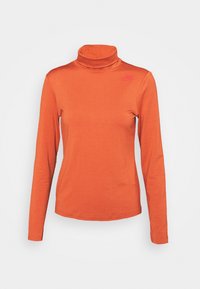 Orange långärmad turtleneck-topp med ett texturerat rutmönster och en liten Nike-logotyp på övre vänstra sidan. Mjuk tygfinish.