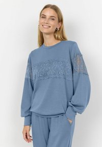 Blue sweatshirt with long sleeves, round neckline, and lace panel detailing across the chest. Soft material with a relaxed fit.
