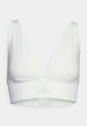 Sutien sport alb cu decolteu adânc în V, bretele late și un material neted și elastic. Prezintă un logo subtil Adidas pe bandă.