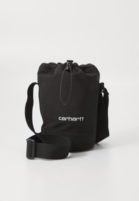 Black drawstring bag made from durable fabric, featuring an adjustable strap and a prominent white logo on the front.