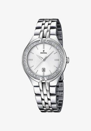 Srebrny metalowy zegarek na rękę z błyszczącą ramką, białą tarczą, cyframi przy 12 i 6, wyświetlaczem daty oraz kryształkowymi zdobieniami wokół tarczy.