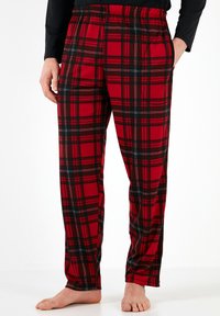 Rødeternet pyjamasbukser med sort, hvidt og rødt mønster, elastisk talje, og sidelommer; afslappet pasform og glat stofstruktur.