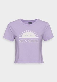 Camiseta recortada de lavanda hecha de algodón suave, con un gráfico de sol blanco con ojos cerrados y el texto "ALMA SOL" debajo. Mangas cortas.