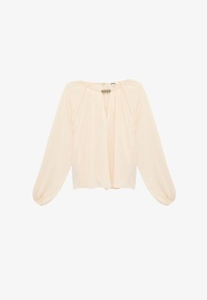 Cream long-sleeve blouse with gathered sleeves, keyhole neckline, and decorative metal clasp detail at the collar.